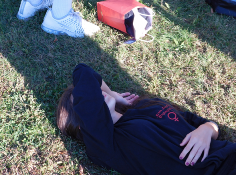 Junior Caroline Tomaselli takes a well-deserved break, exasperated from having to control the junior boys.