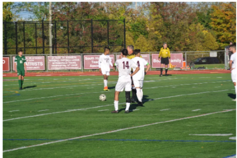 Anthony Palazzolo (14) and Bobby Cerrito (4) prepare to take a free kick just about 10 yards away from the 18 yard box. 